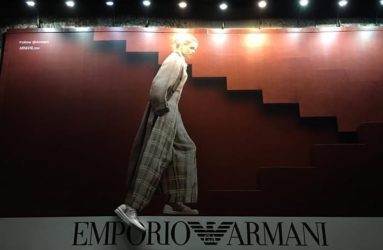 Armani billboard at night with three dimensional shoe