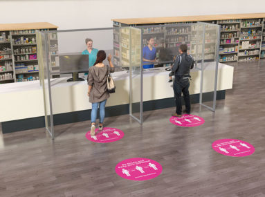 Protective barriers with floor graphics at a pharmacy