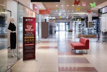 Freestanding COVID-19 signage in a retail environment
